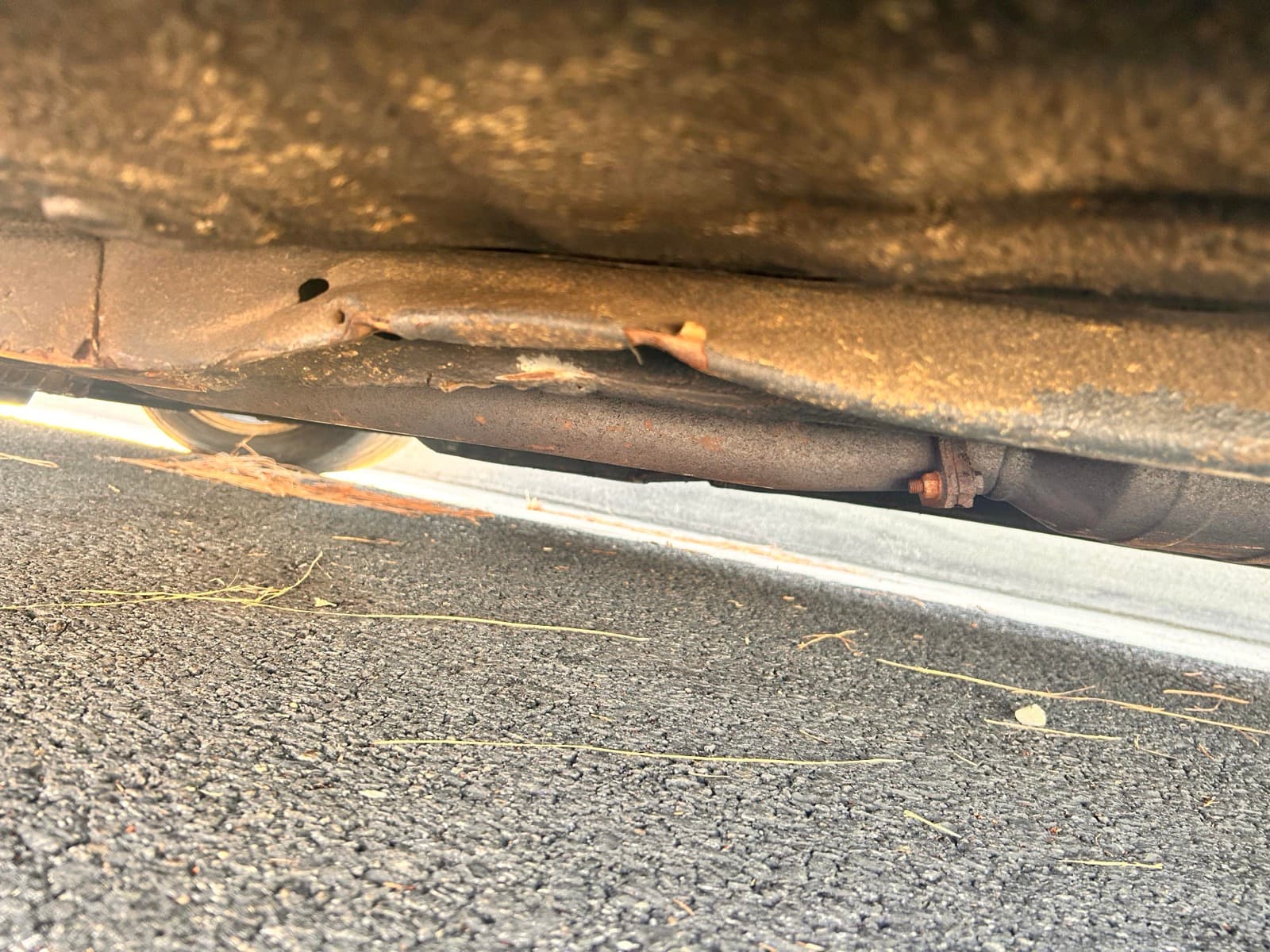 Kinked frame rail with fresh undercoating masking a repair