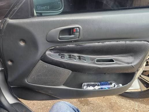 Overspray on a door seal revealing a resprayed quarter panel