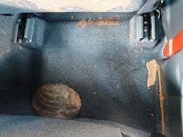 Smoke staining under carpet edge in a fire-damaged interior